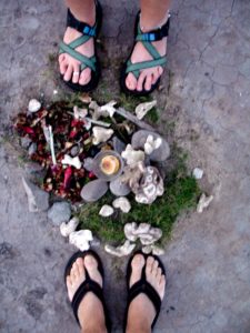 feet encircling found treasures on the beach