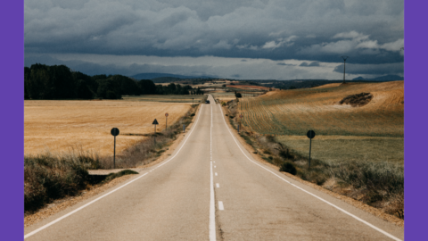 image of a very long straight road with mountains in the background