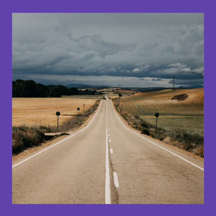 image of a very long straight road with mountains in the background