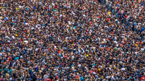 image of thousands of people standing closely together. mainly their heads and shoulders are only seen